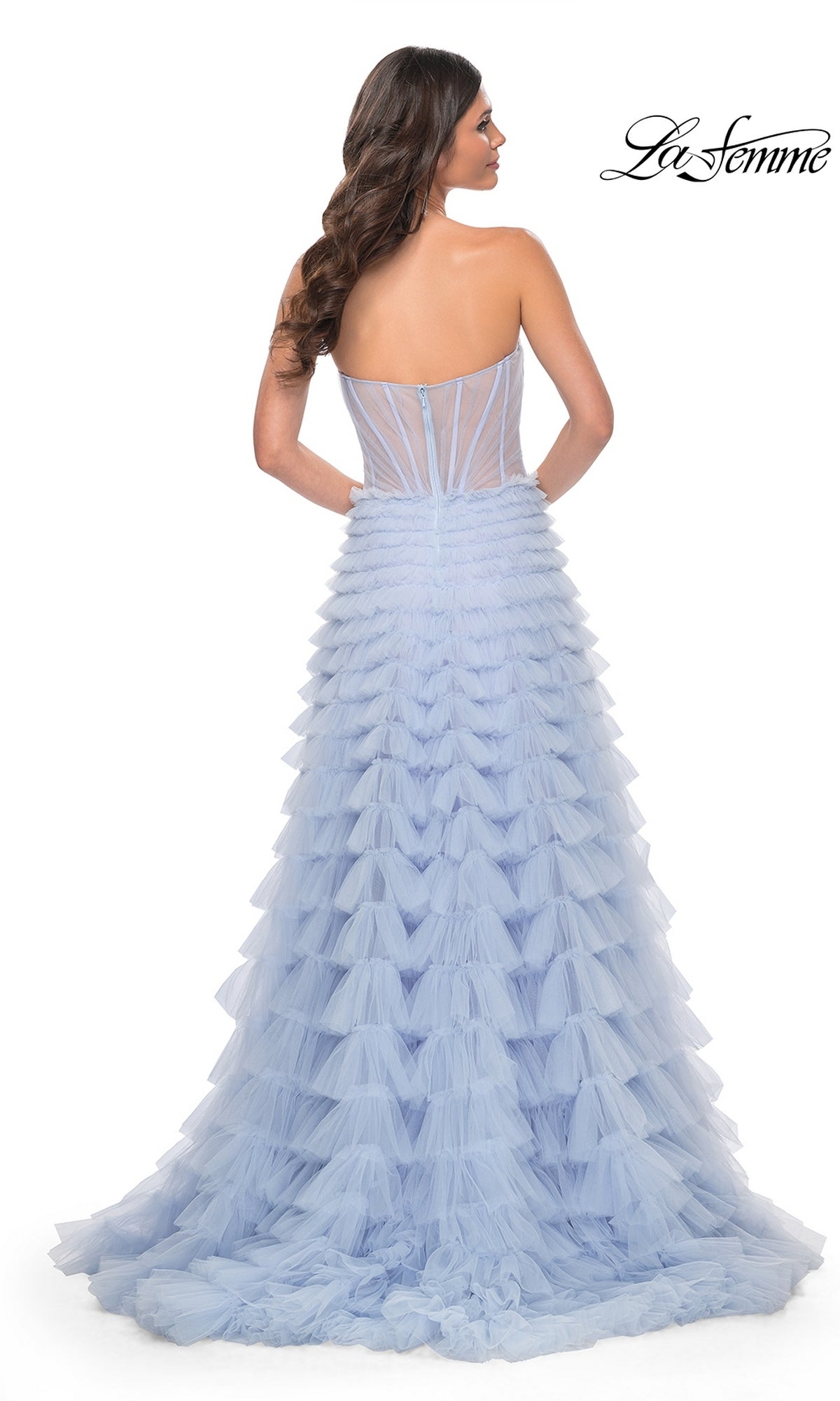 A woman faces away in a strapless, light blue Long Ruffled A-Line Prom Ball Gown (La Femme 32447) with a sheer corset back. La Femme logo appears in the top right corner.